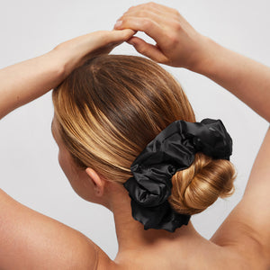 KITSCH Pillow Scrunchies® in Satin 4pc - Black — model lifestyle — black satin scrunchie styled in hair — soft enough to sleep in, cute enough to wear out