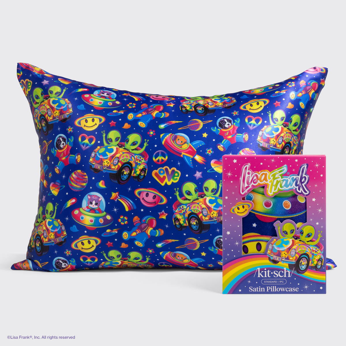 KITSCH Lisa Frank x Kitsch Satin Pillowcase in Zoomer & Zorbit — satin pillowcase in a deep blue space print with green aliens, smiley planets, and rainbow cars, shown with its Lisa Frank box — reduces friction against hair and skin, tame frizz and reduce breakage, prevent facial creases — queen/standard-size satin pillowcase for smoother hair and skin overnight