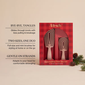 KITSCH Terracotta Detangling Duo 2pc Set — infographic of the red plaid retail box with the terracotta full-size and mini flexi brushes beside pine cones and greenery, with callouts Bye-Bye, Tangles, Two Sizes, One Duo and Gentle on Strands — Includes full-size and mini brushes for easy detangling at home or on the go — gently detangles wet or dry hair for smoother, more manageable strands